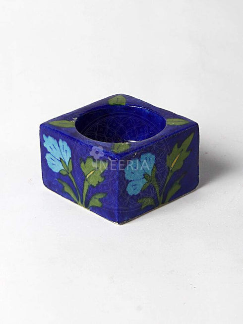 Turquoise Flower With Green Leaves on Blue Base